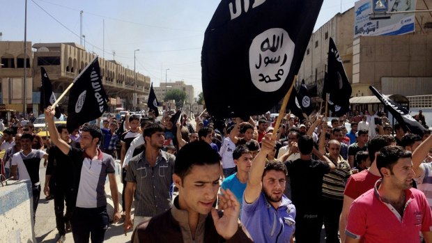 Demonstrators chant pro-Islamic State group slogans in Mosul, Iraq in 2014.