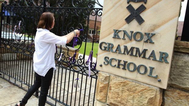 Ribbons being tied to the gate of Knox Grammar School.