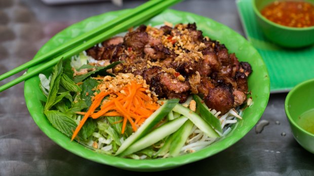 Bright green plates are laden with barbeque pork vermicelli.