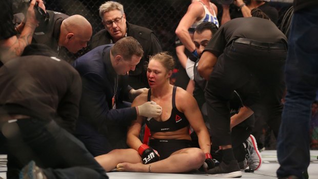 Ronda Rousey receives medical treatment after her loss.