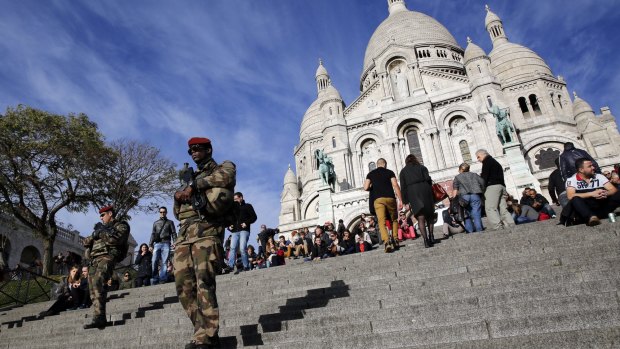 Soldiers patrol in front of the Sacre Coeur basilica, in Paris.