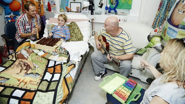 Jack Woodhams plays the xylophone with music therapist Matt Ralph during his stint in hospital.