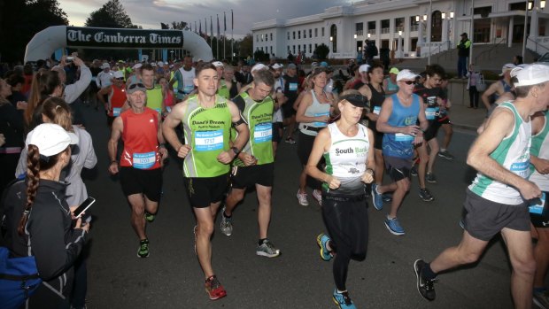 Runners set of the start line at the beginning of the Canberra Times Marathon in front of Old Parliament House.  