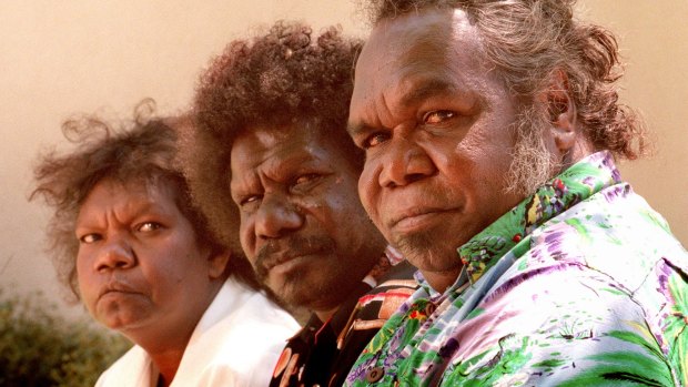 "They need one foot in both worlds": Aurukun Shire councillor Jonathon Korkaktain, centre, believes local boys like the ones above should be sent away to boarding school after they turn nine.