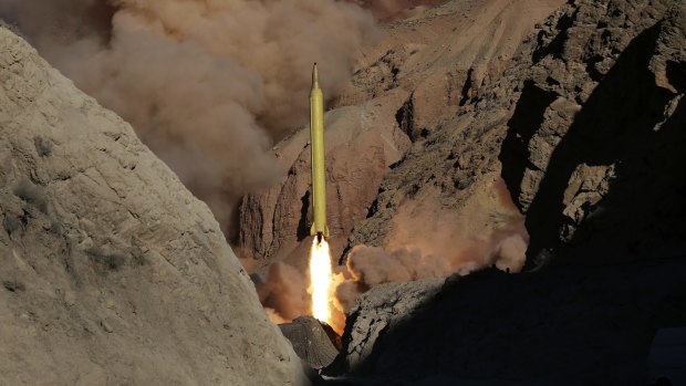 In this photo obtained from the Iranian Fars News Agency, a Qadr H long-range ballistic surface-to-surface missile is fired by Iran's Revolutionary Guard, during a maneuver, in an undisclosed location in Iran.