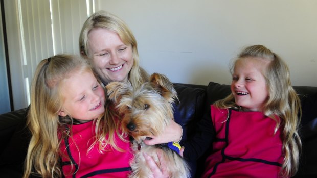'The biggest hurdle we have faced is people refusing her access to places because she is not a labrador': Adrienne Cottell with her identical twin daughters, Hannah and Olivia Weber, aged 7, and their dog Molly.
