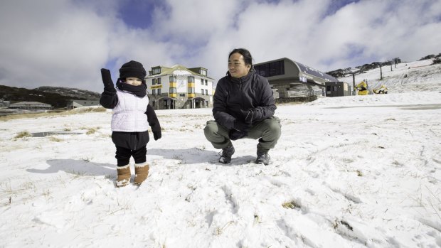 Sherwin Sinlao and son, Shiloh, of Brighton, enjoy the snow at Perisher on Wednesday.