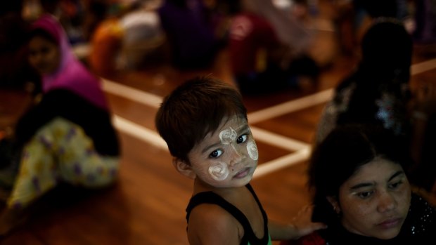 A Rohingya boy waits with other migrants at the temporary detention centre in Langkawi on Tuesday.