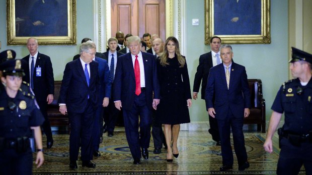 Senate Majority Leader Mitch McConnell, escorts US President-elect Donald Trump and First Lady-elect Melania Trump to a meeting at the US Capitol on Thursday. 