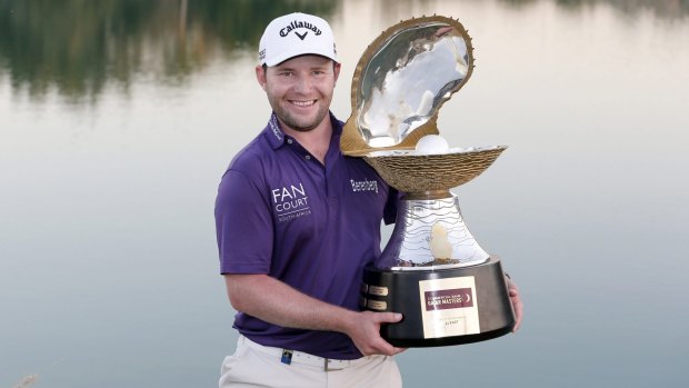 Branden Grace of South Africa poses with the trophy after the final round of the Qatar Masters at the Doha Golf Club on Saturday.
