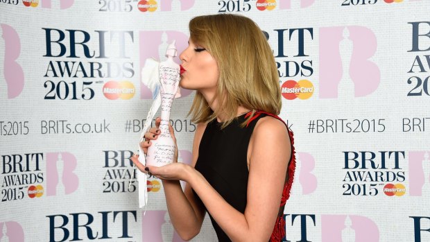 Taylor Swift poses with her International Female Solo Artist Award at the BRIT Awards on February 25, 2015 in London.