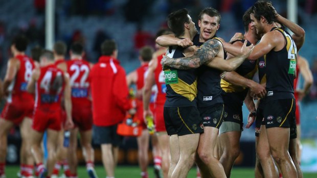 Nathan Gordon and Dustin Martin celebrate victory during the round 23 match against the Swans.