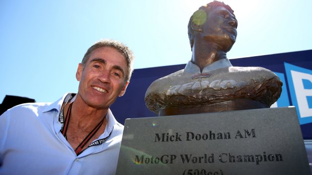 Five time 500cc world champion Michael Doohan next to a bronze bust in honour of his achievements at the Phillip Island Grand Prix Circuit.