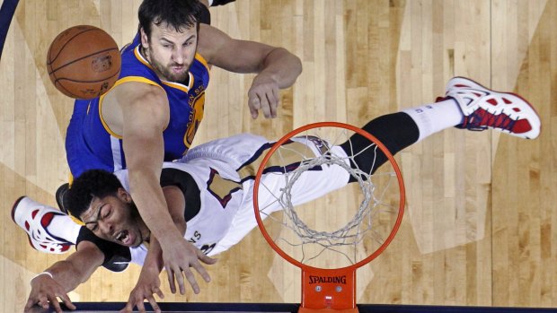 Guarding the rim: Golden State Warriors centre Andrew Bogut blocks a shot as New Orleans Pelicans forward Anthony Davis goes to the basket.