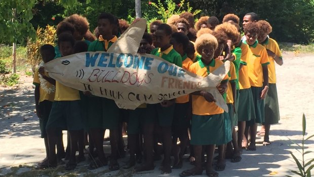 Warm welcome: Local school children welcome present and former Bulldogs.