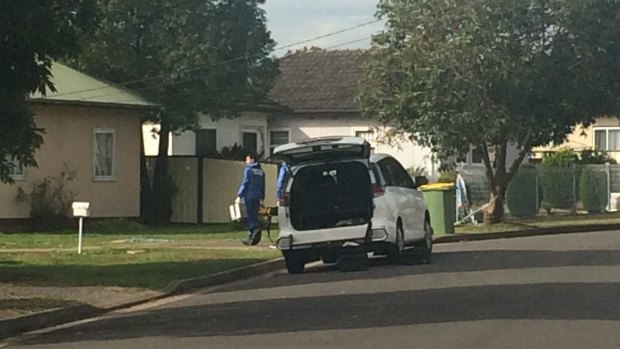 Forensic officers enter the Belmore Street house where the body of Mahmoud Hrouk, 16, was discovered on Sunday.