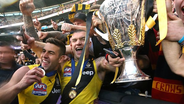 Mayhem: Dustin Martin and Jack Graham with the premiership trophy.