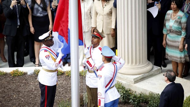 The Cuban flag is raised at the Cuban embassy during an official ceremony in Washington.