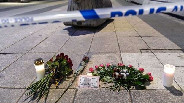 Candles and flowers are placed near the site of the attack.