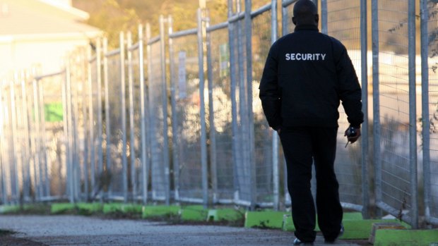 A security guard in Canberra: People with no hope of getting security work are being put through the cost and time of qualifying.