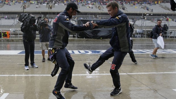 Daniil Kvyat and Daniel Ricciardo dance during the rain delay.