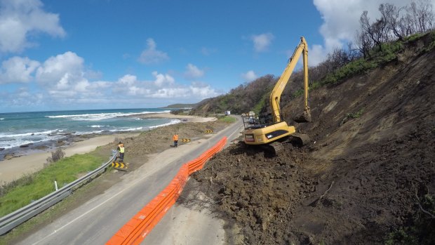 Soil works are carried out along the Great Ocean Road at Wye River. The road has been closed after landslides. 