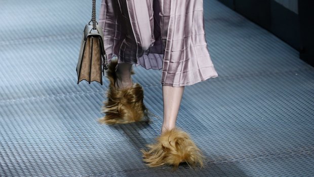 In this Wednesday, January 5, 2015 file photo, a model wears footwear with wisps of fur as part of the Gucci women's Fall-Winter 2015-2016 collection, in Milan, Italy. 
