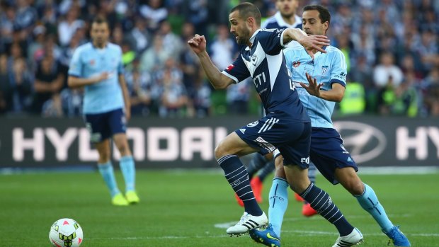 Fair game? Carl Valeri of the Victory is challenged by Alex Brosque of Sydney FC.