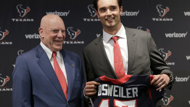 Houston Texans quarterback Brock Osweiler, right, holds his new jersey as he poses with owner Bob McNair.