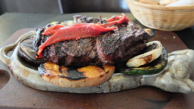 A succulent grilled steak and vegetables, traditional food in Buenos Aires, Argentina. 