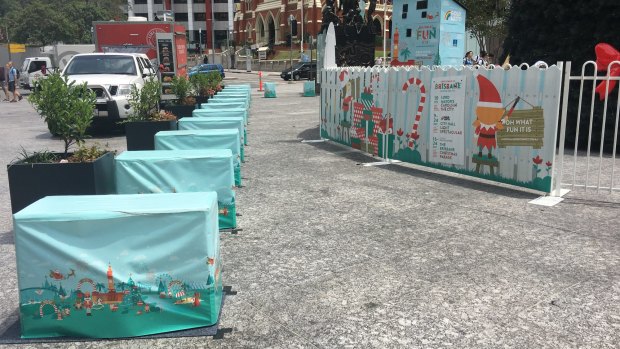 Concrete blocks, covered in Christmas wrapping, have been installed around Brisbane's King George Square.