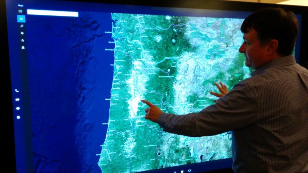 Microsoft's Brian Eskridge uses the Surface Hub to demonstrate the location of a Portland, Oregon, manufacturing plant. 