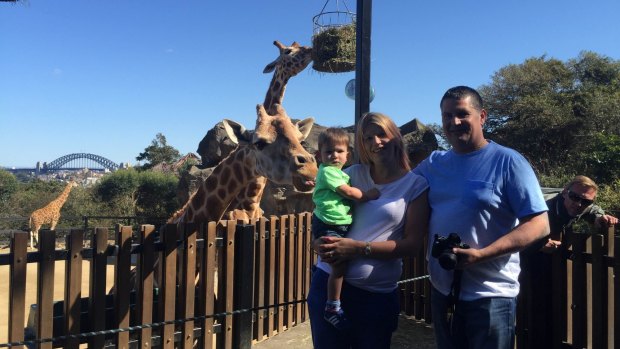 Tall friends: Anderson with his partner Rachel and son Tai enjoying the sights of Sydney at Taronga Zoo.