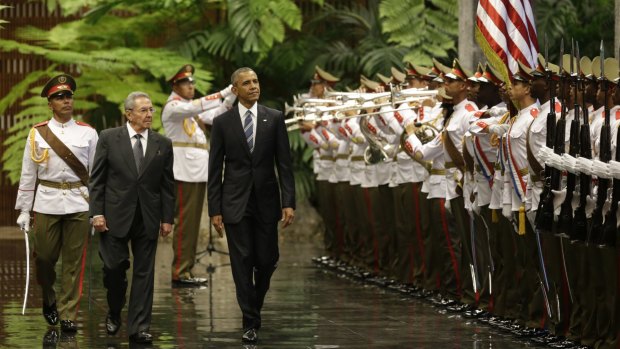 Cuba's President Raul Castro, left, walks with US President Barack Obama as they inspect the guard in Revolution Palace on Monday.