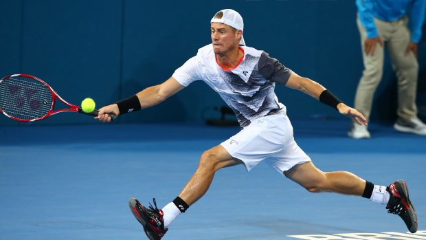 Lleyton Hewitt stretches to effect a return to Sam Groth.