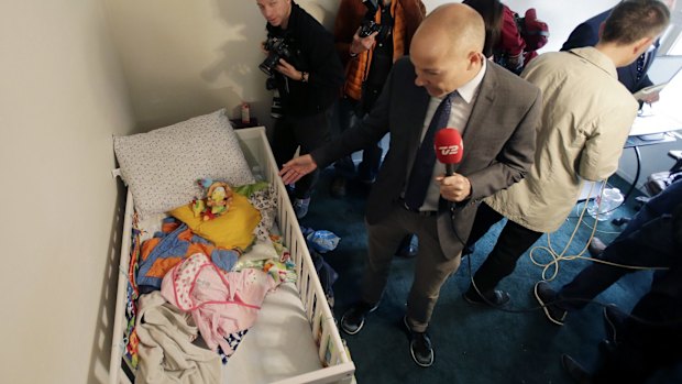 Members of the media crowd into a child's room in an apartment in Redlands, California, shared by San Bernardino terrorists Syed Farook and his wife, Tashfeen Malik.