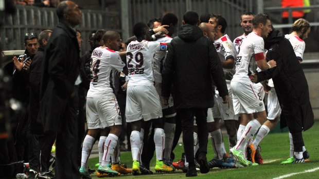 Cheick Diabate celebrates his goal with teammates and coach Willy Sagnol.