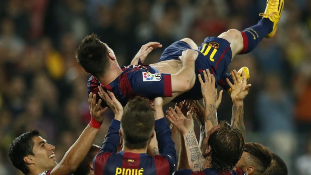 Lionel Messi's teammates hold him aloft after his hat-trick.
