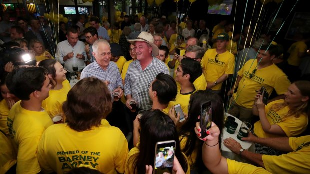 Prime Minister Malcolm Turnbull and Barnaby Joyce celebrate his re-election with National party supporters.