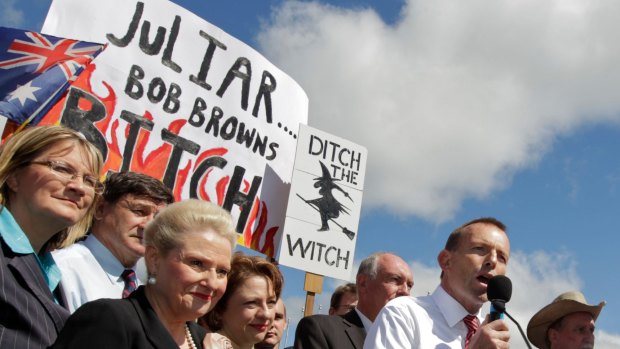 Tony Abbott in front of the infamous poster at the No Carbon Tax Rally outside Parliament House in 2011. 