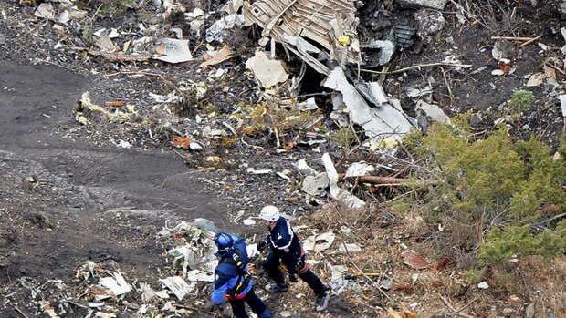 French investigators sift through wreckage at the crash site.