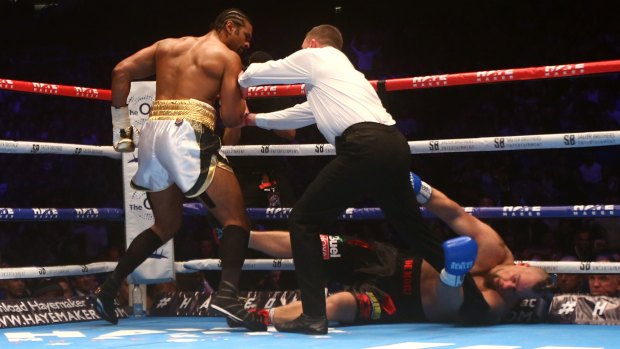 Heavy blow: David Haye is pushed away by the referee after knocking out Mark De Mori at The O2 Arena in London.