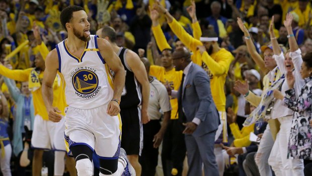 Golden State Warriors guard Stephen Curry reacts after scoring against the San Antonio Spurs.