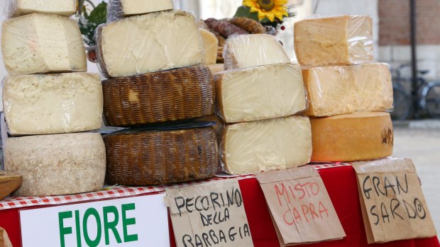 The island has remarkable cuisine. Pictured: Sardinian cheese at the market.