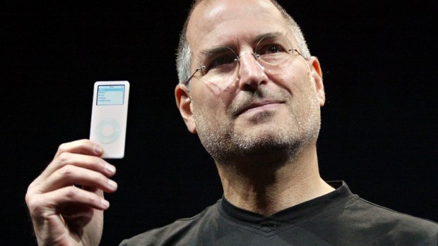 Apple CEO Steve Jobs holds up the new iPod Nano after introducing it in September 2005.