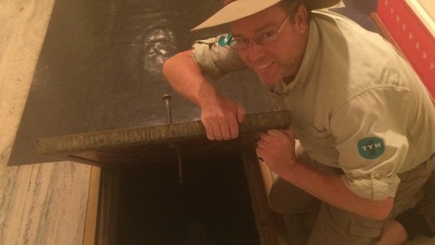 Tim the Yowie Man inspects a trap door at Old Parliament House.