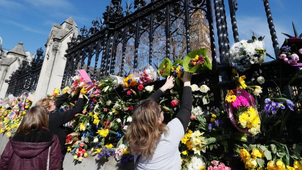 People place flowers outside Britain's Parliament, for the victims of the Westminster attack in March.