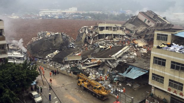 Rescuers search for survivors among the collapsed buildings after a landslide in Shenzhen, in China's southern  Guangdong province on Sunday.