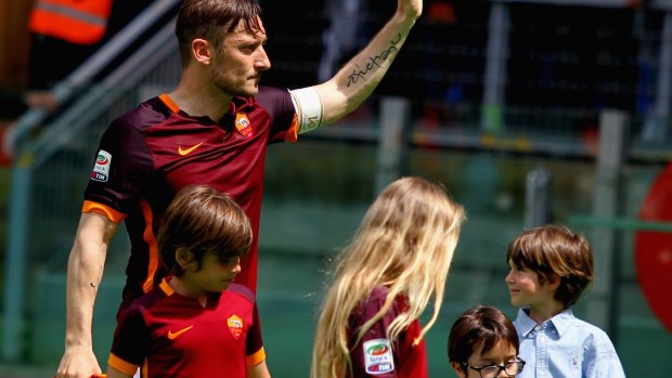 Totti greets fans after his milestone.