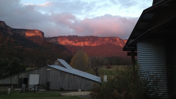 A fiery sunset seen  from the deck of Woolshed Cabins, looking over the historic woolshed  to the Kanimbla escarpment. 